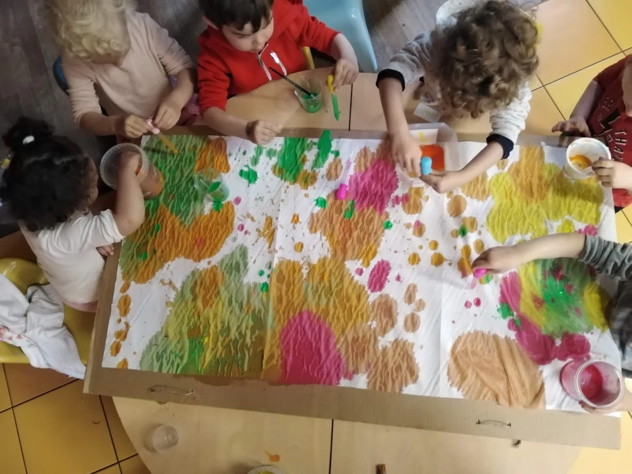 Bambini impegnati in una pittura collettiva